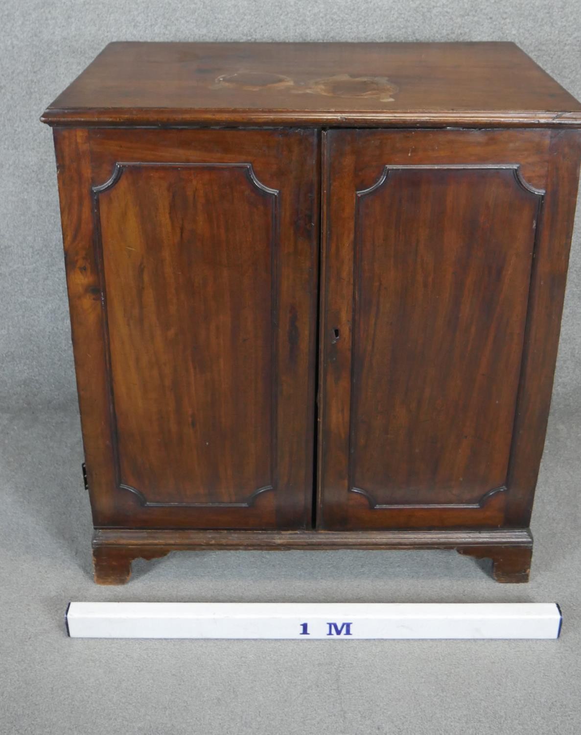 A Georgian mahogany side cabinet with panel doors enclosing open space on bracket feet. H.107 W.96 - Image 2 of 4