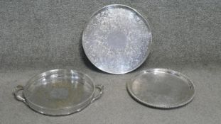 Three circular silver plated serving trays, one with a pierced gallery and engraved floral and