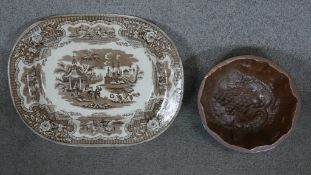 A large 19th century brown and white transfer design meat platter along with a stoneware jelly mould