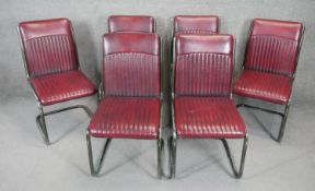 A set of six vintage dining or side chairs in ribbed burgundy faux leather upholstery on tubular