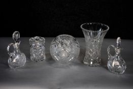 A pair of cut crystal oil pourers with stoppers along with two cut crystal vases and a lidded