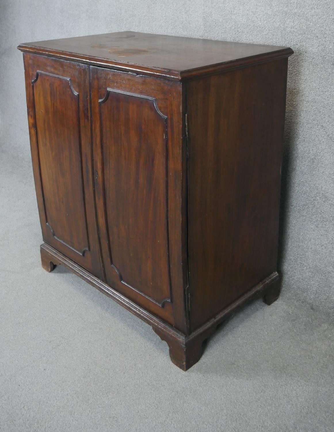 A Georgian mahogany side cabinet with panel doors enclosing open space on bracket feet. H.107 W.96 - Image 4 of 4