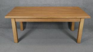 A contemporary planked top refectory style dining table on square supports by Fired Earth. H.77 W.