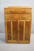A mid century vintage oak tallboy with frieze drawers above panel doors on plinth base. H.123 W.83
