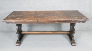 A mid century oak country antique style refectory table on stretchered trestle supports. H.73 x W.