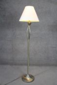 A brushed chrome and brass standard lamp on a circular base. H.147cm