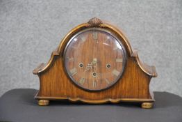 A mahogany veneered Wellington style quarter chiming mantle clock with brass movement and Roman