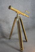 An antique brass nautical double barrel telescope on adjustable teak and brass tripod stand. H.100CM