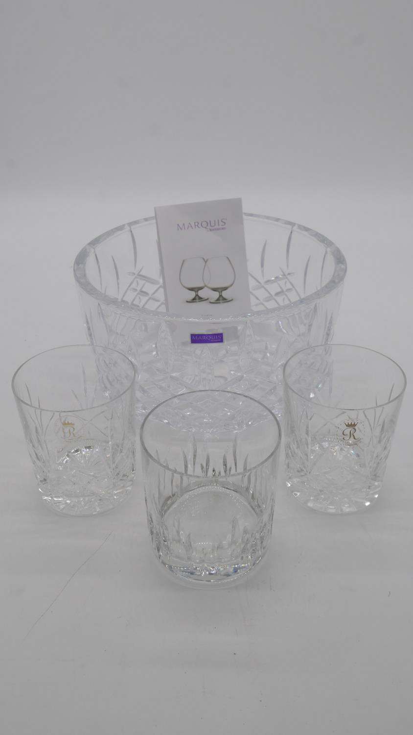 A boxed marquis cut crystal glass bowl and three cut crystal whisky tumblers with makers labels.