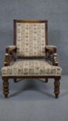 A late 19th century walnut framed armchair in floral upholstery on turned tapering supports.