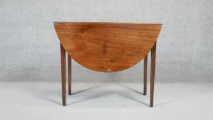 A 19th century mahogany drop flap dining table on reeded square tapering supports. H.70 W.90 D.40 (