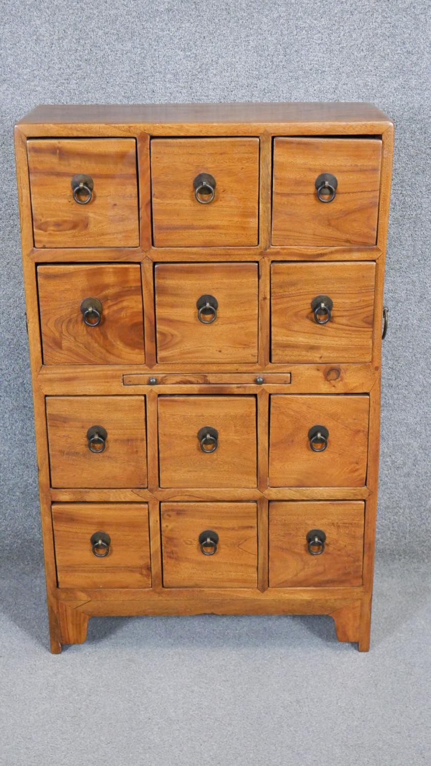 An Eastern hardwood spice chest with pull out slide and twin metal carrying handles. H.97 x W.60 x