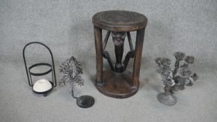 An Asian carved hardwood stool in the form of a seated man, engraved design to the top along with
