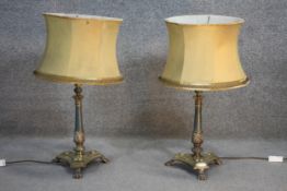 A pair of Victorian brass and copper table lamps on triangular bases with lion paw feet. H.70 W.35