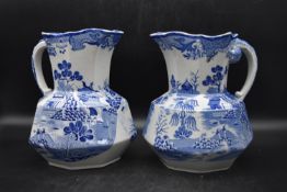 A pair of 19th century blue and white 'Masons' ironstone Hydra jugs, decorated with forest scenes,