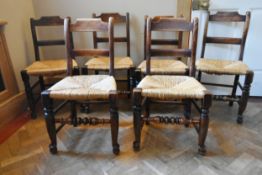 A set of six 19th century oak bar back dining chairs with woven rush seats on turned stretchered