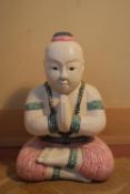 An Oriental carved and painted polychrome Buddha figure, meditating. H.50 W.35 D.19cm