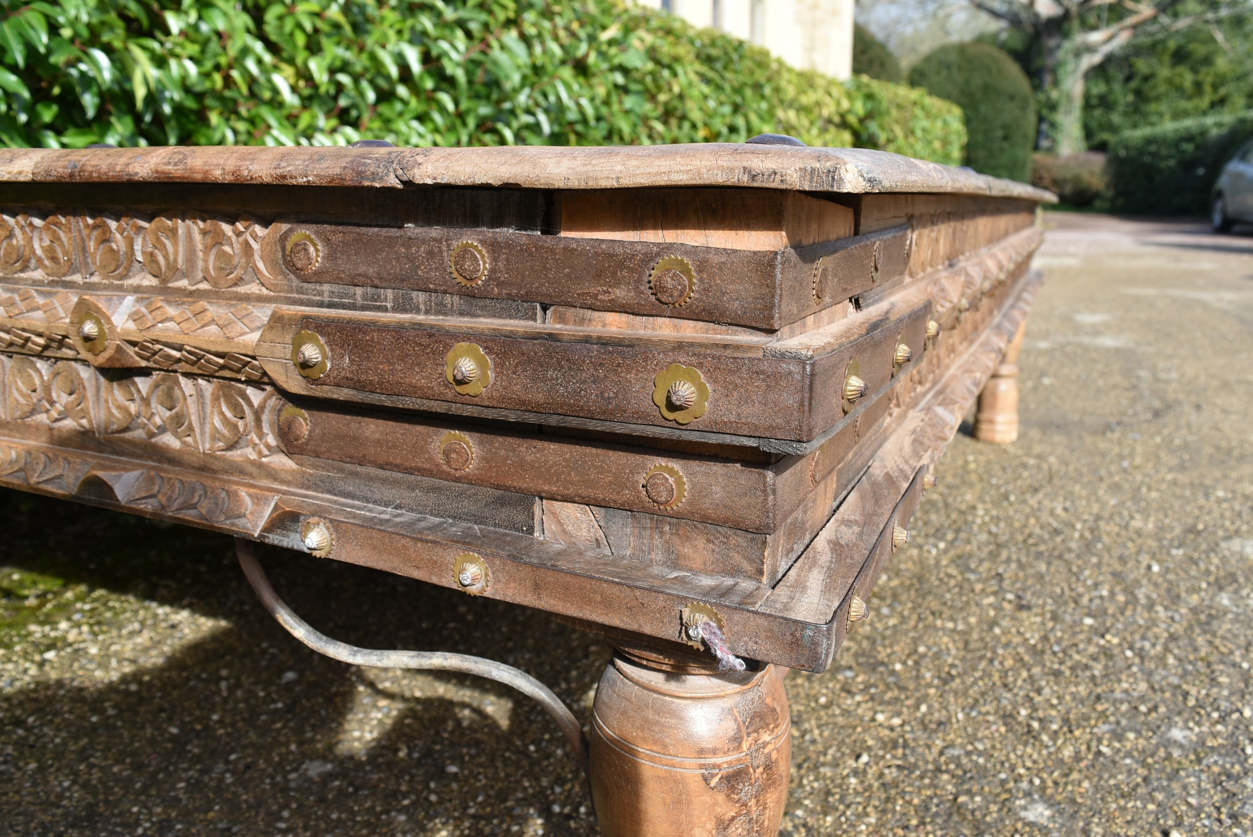 A large Indian teak carved and metal bound low table. - Image 4 of 8