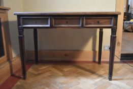 A Continental fruitwood three drawer writing table on square tapering supports. H.69 W.112 D.65cm