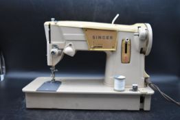 A vintage Singer sewing machine, along with adaptable pedal, in a Wallenger's sewing bag. H.30 W.