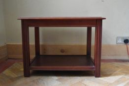 A mahogany coffee table with glass inset top on square supports. H.50 W.66 D.49cm