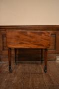 A 19th century mahogany drop flap Pembroke table fitted with frieze drawer on turned tapering