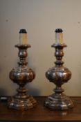 A pair of distressed painted and carved table lamps on baluster turned columns and stepped bases.