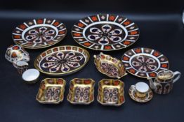 A part Royal Crown Derby tea set. Including, wall hanging plate, two side plates, a miniature cup