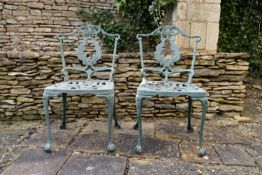 A pair of pierced wrought metal and painted garden chairs. H.82 W.42 D.42cm (2)