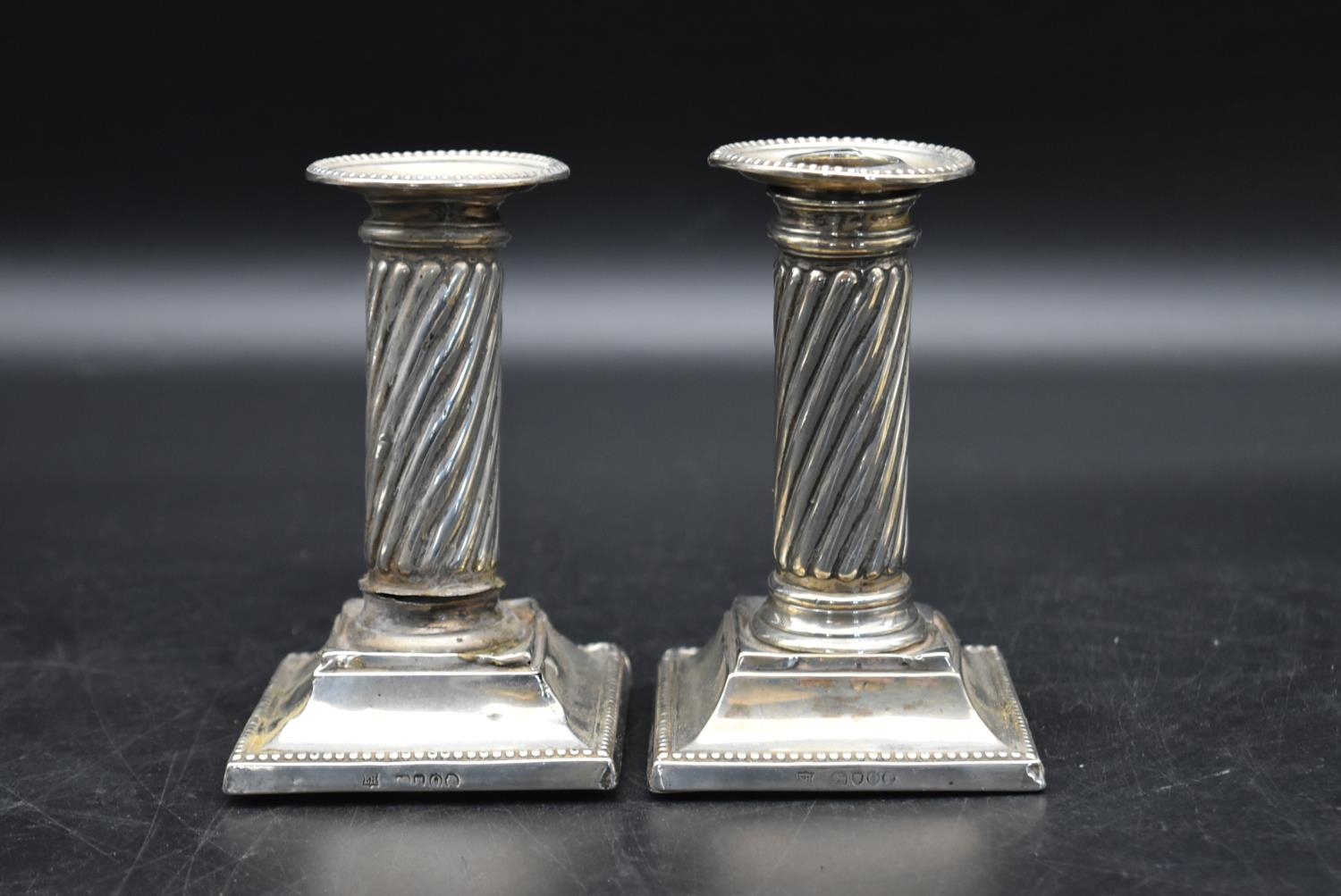 A pair of silver candlesticks with a twisted style to the column and beading decoration to the base, - Image 7 of 13