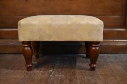 A 19th century style foot stool in floral upholstery on mahogany carved baluster supports. H.35 W.53