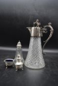 An early 20th century crystal cut glass claret jug with silver plated handle and lid, along with a
