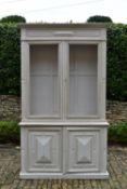 A C.1900 French Provincial painted two section bookcase the upper section fitted with mesh doors