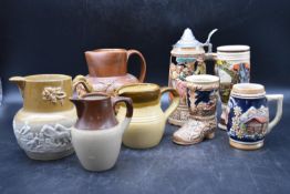 A collection of four Tobacco jugs, along with a collection of German beer steins. H.20 W.16cm (