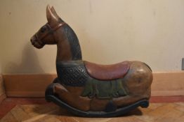 An Eastern carved and painted polychrome rocking horse. H.66 W.70 D.20cm