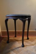 A mid century mahogany Georgian style occasional table with plate glass top on carved cabriole