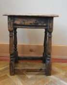 An antique oak joint stool on baluster turned stretchered supports. H.56 W.45 D.27cm