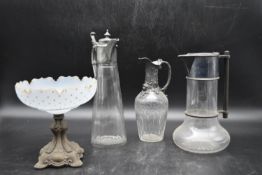 A collection of Edwardian style glassware. Including three claret jugs, one with repousse decoration