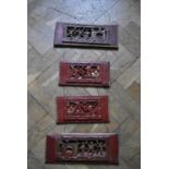 A set of four Chinese carved and pierced lacquered wall hanging panels. H.76 W.36cm.