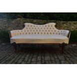 A Victorian carved rosewood frame sofa in deep buttoned damask upholstery on cabriole supports. H.89