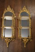 A pair of 19th century wall mirrors in gilt Rococo laurel and ribbon decorated frames with triple