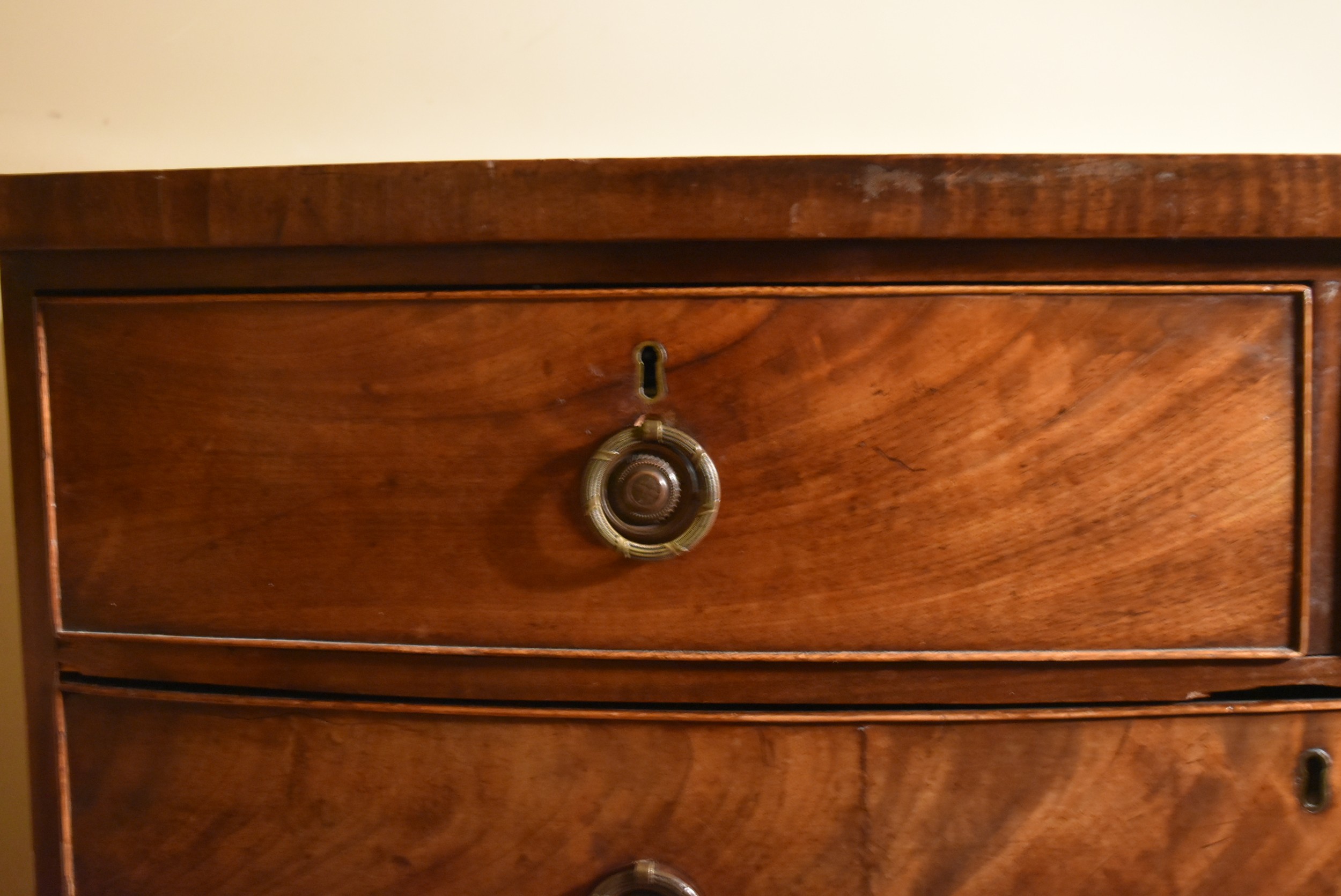 A Georgian flame mahogany bow fronted chest on swept bracket supports., H.107 W.109 D.52cm - Image 5 of 7