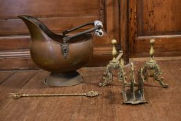 A Victorian copper helmet shaped coal scuttle, along with a pair of brass fire dogs and other