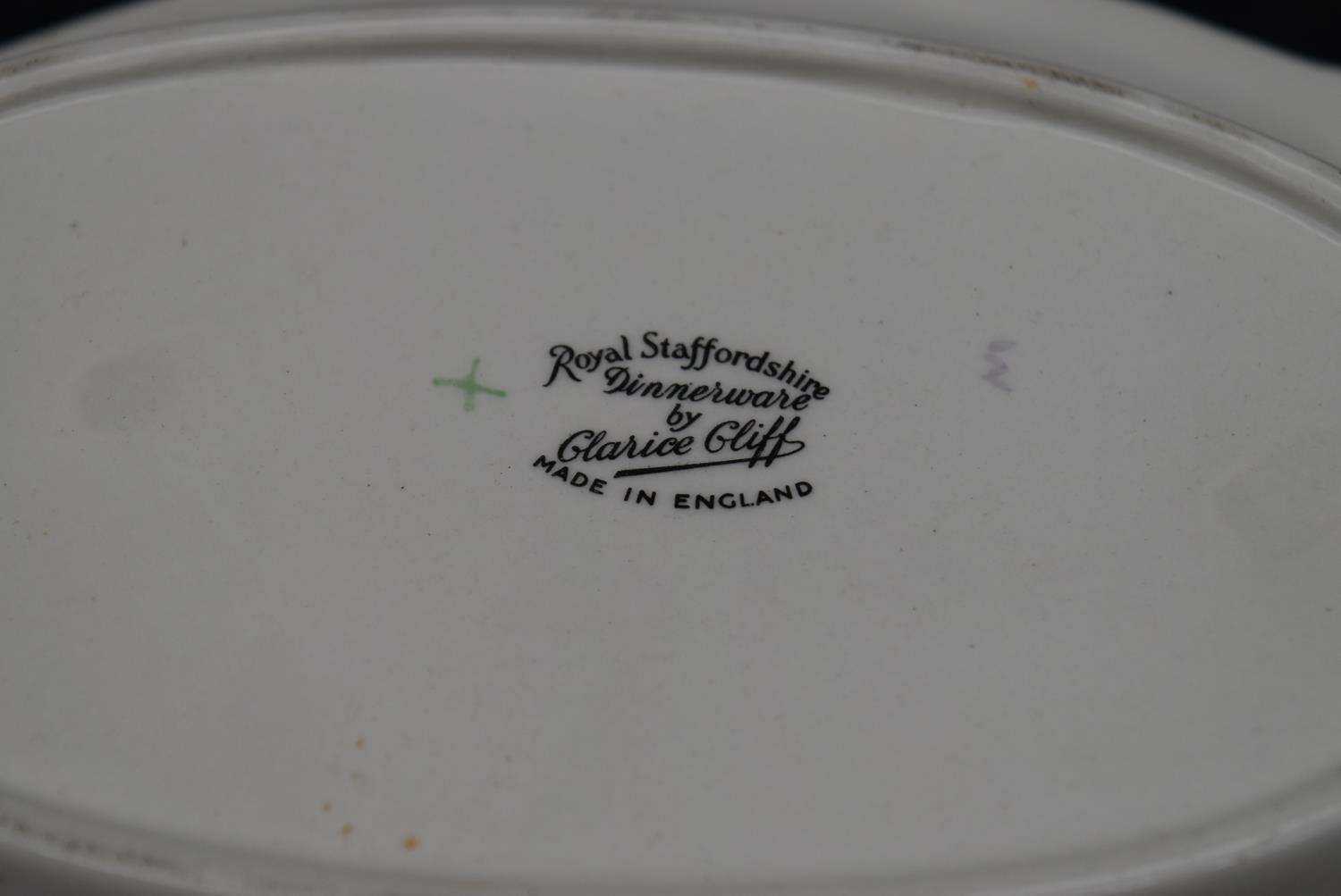 A hand painted Royal Staffordshire dish by Clarice Cliff, along with a porcelain saucer, depicting - Image 4 of 8