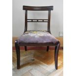 A Regency mahogany dining chair with tapestry upholstered drop in seat on sabre supports. H.70 W.