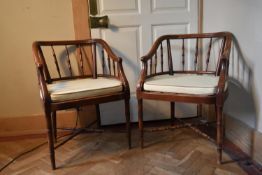 A pair of tub shaped faux bamboo armchairs with fitted squab cushions on stretchered supports. H.