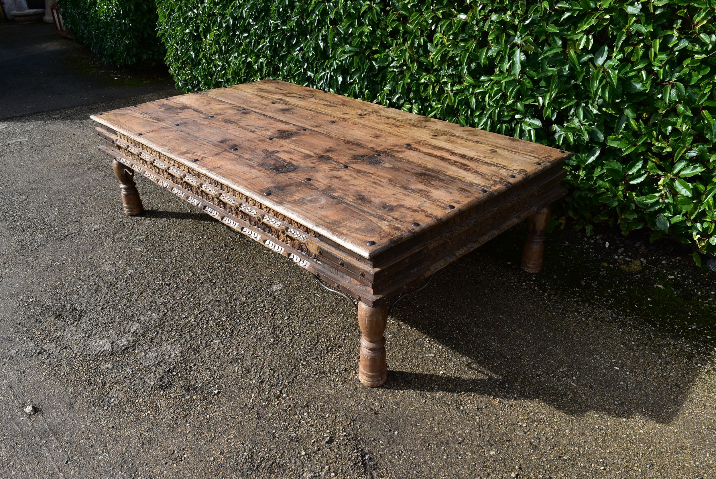 A large Indian teak carved and metal bound low table. - Image 3 of 8