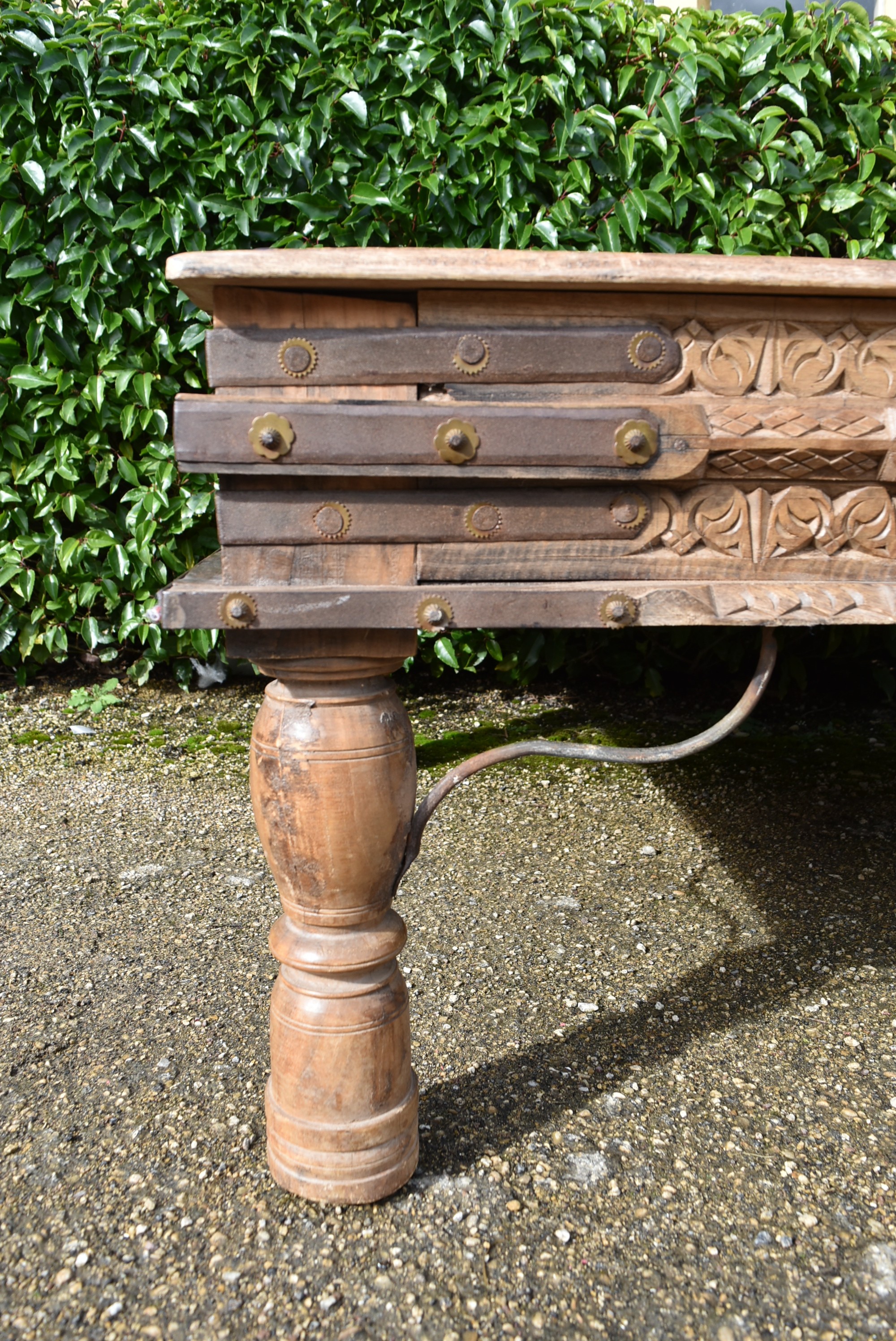 A large Indian teak carved and metal bound low table. - Image 5 of 8
