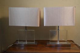 A pair of contemporary Perspex table lamps on chrome base with cream rectangular shades. H. 54 W.