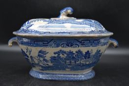 A 19th century blue and white casserole dish with scrolling drop handles either side and lid,